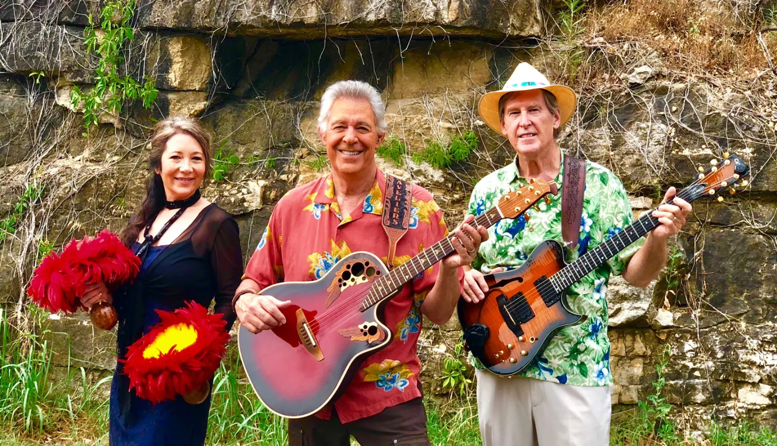 Three people are holding guitars and posing for a picture.